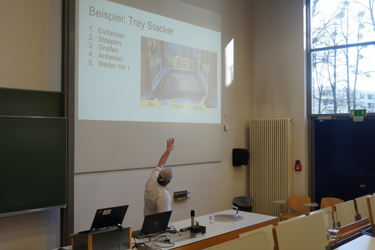 Michael Grampp explaining automation processes using a tray stacker example at AALE 2026.