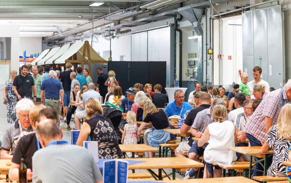 Visitors gather in the courtyard during esmo AG’s Open House marking its 25th anniversary in Rosenheim.