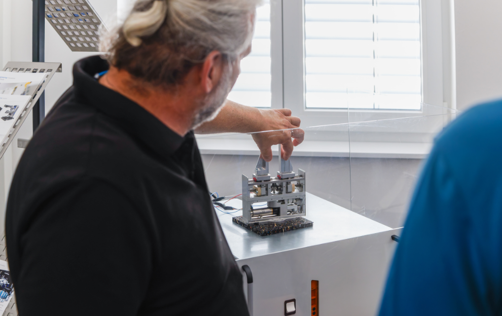 An employee explains a technical system to visitors during the Open House.