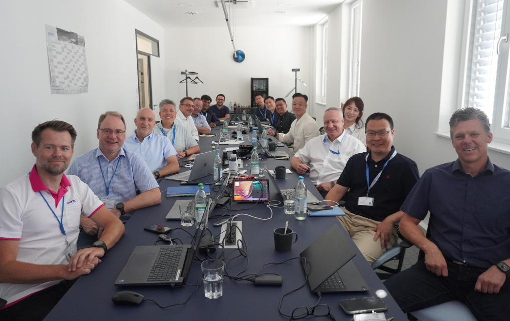International esmo colleagues attending a meeting together in a conference room.