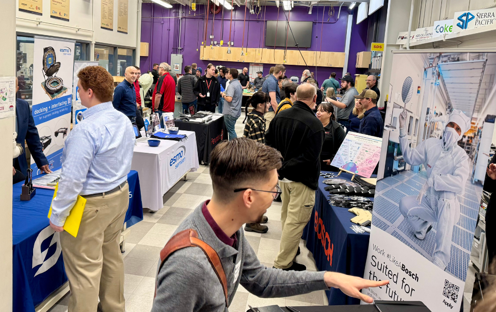 Overview of the esmo semicon booth at the Sierra College Mechatronics Career Fair with students and exhibitors.